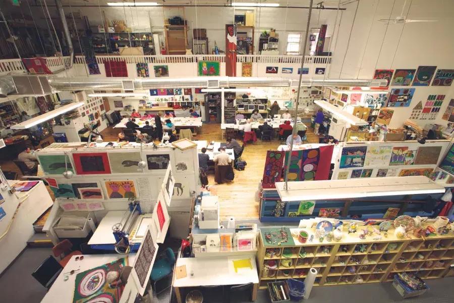 The floor of Creativity 探索d, with an assortment of desks and works of art, seen from overhead.